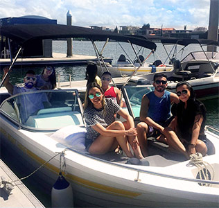 8 person bow rider hire boat with 7 people on board docked in Surfers Paradise on the Gold Coast